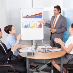 Coworkers Applauding Businessman